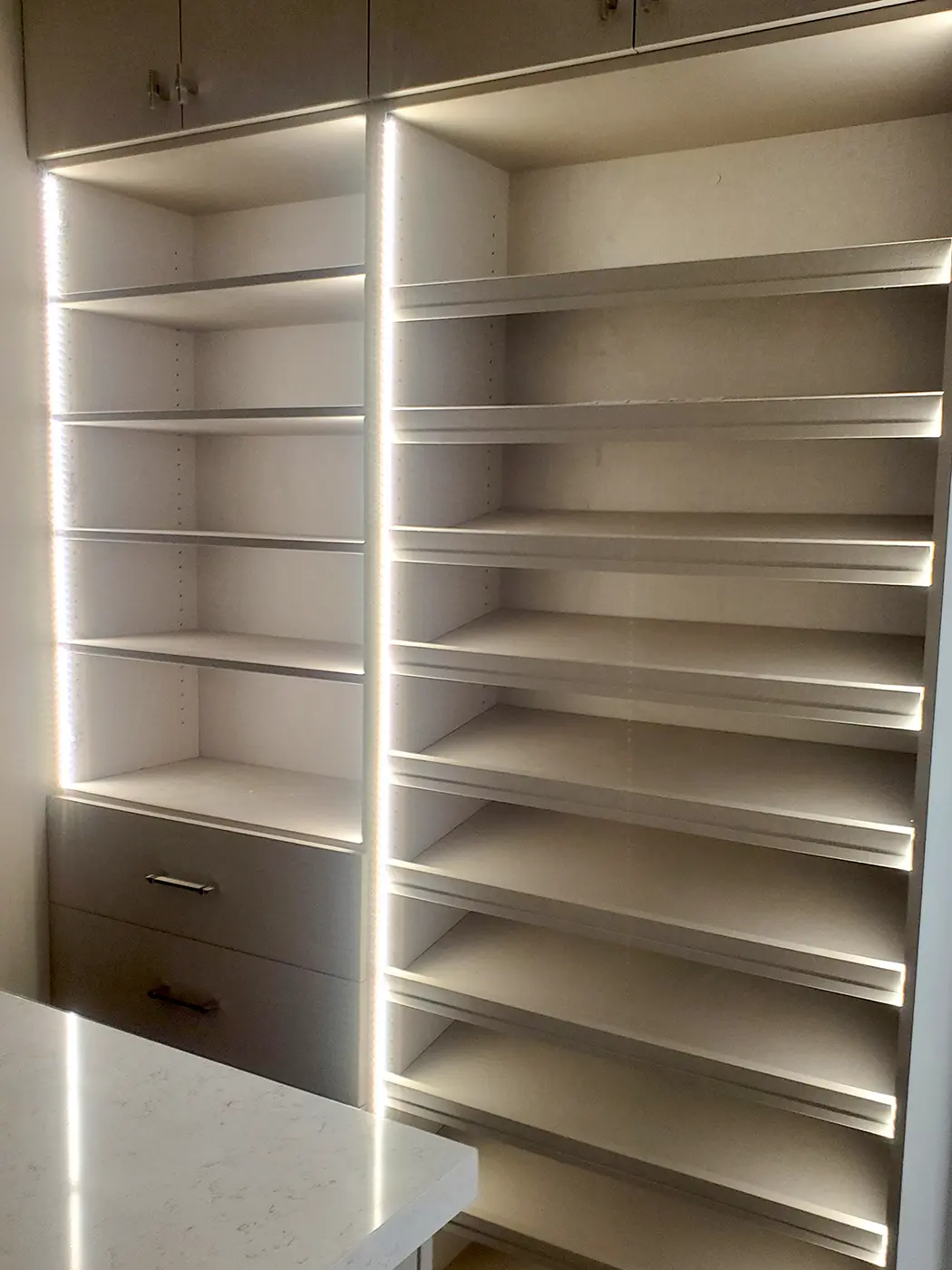 Accent lighting installed on custom closet shelving by Camson Electric in a Utah home