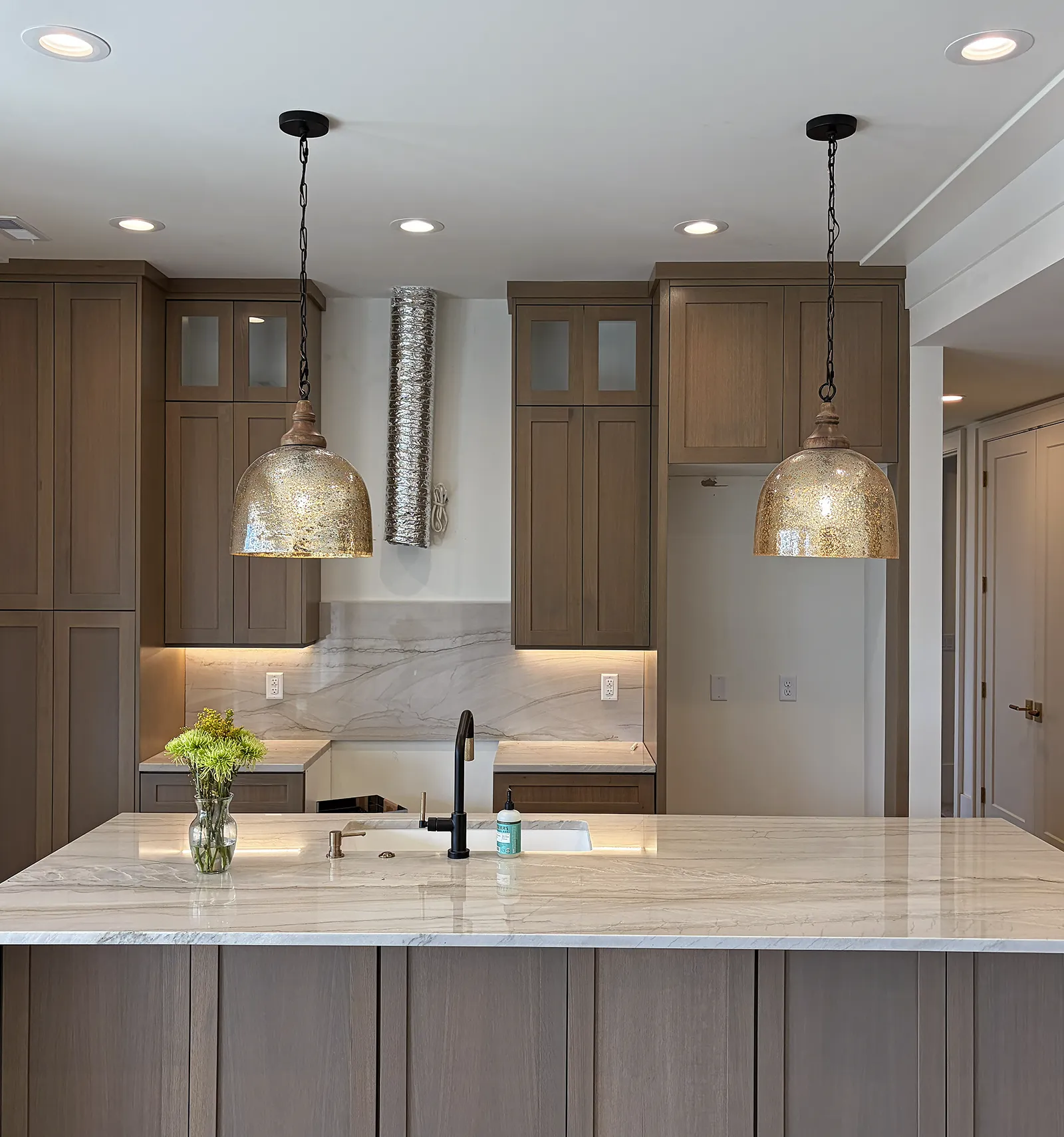 Modern kitchen pendant and recessed lighting installation in a custom Utah home by Camson Electric