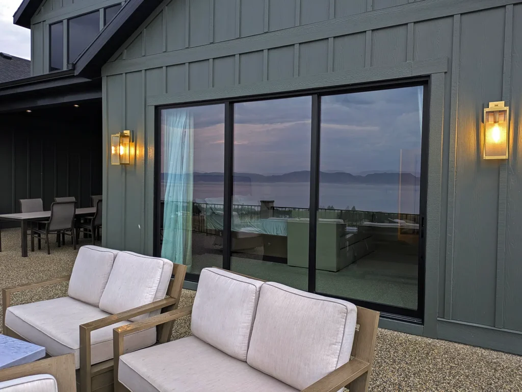 Wall lights beside large glass doors at an outdoor seating area