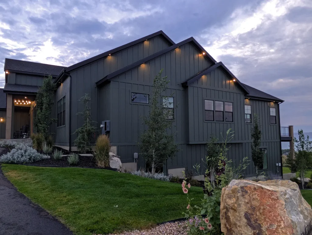 Side elevation of the home with exterior lights beneath the roofline